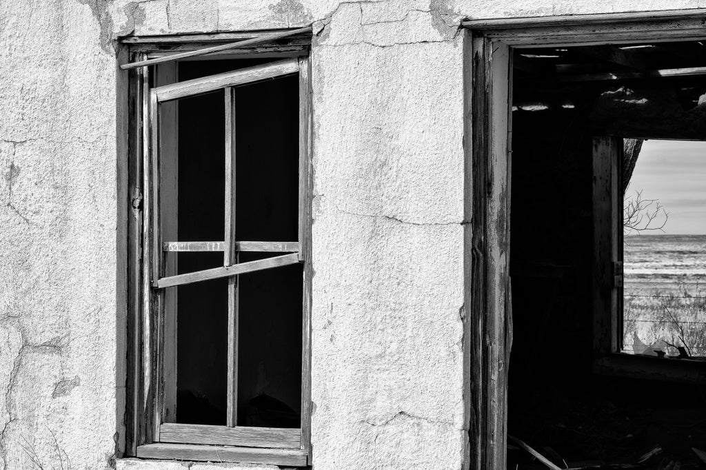 Black and white photograph of the abandoned ruins of the State Line Motel on a rarely visited stretch of old Route 66 in the ghost town of Glenrio, New Mexico.