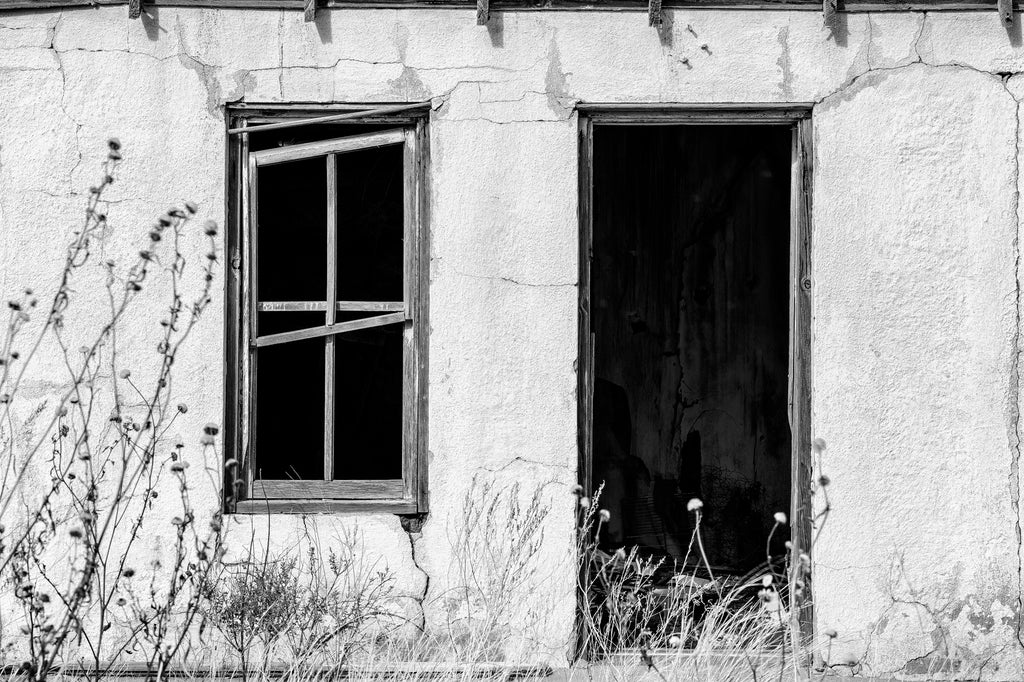 Black and white photograph of the abandoned ruins of the State Line Motel along a lonely stretch of old Route 66 in the near ghost town of Glenrio, New Mexico.