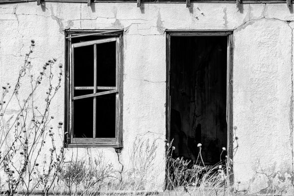 Black and white photograph of the abandoned ruins of the State Line Motel along a lonely stretch of old Route 66 in the near ghost town of Glenrio, New Mexico.