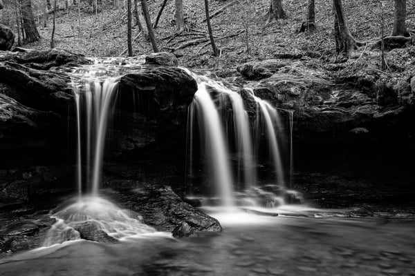 Black and white landscape photograph of DeBord Falls in dramatic light at Frozen Head State Park in the mountains of East Tennessee.