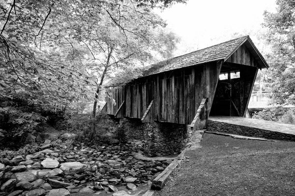 Black and white photograph of the old Pisgah Covered Bridge, built in 1911 along a rural highway in North Carolina at a cost of $40.
