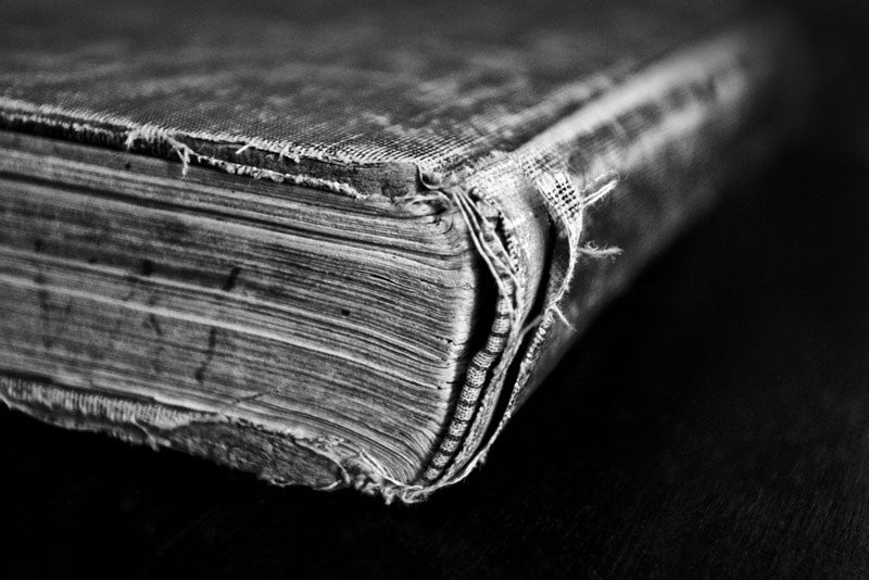 Black and white photograph of a tattered and worn old book, A Short History of England, published in 1904 and written by Edward P. Cheyney. Found in a used bookstore in Texas, this textbook was once owned by Iva Carter of Greenville, Texas, who left handwritten notes throughout the text.