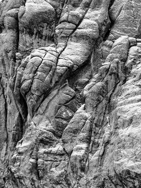 Black and white landscape photograph of a Black Hills rock outcropping covered with a light dusting of snow.