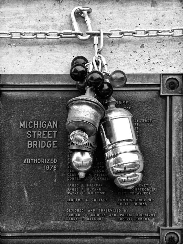 Black and white architectural detail photograph of the Michigan Street Bridge in downtown Milwaukee.