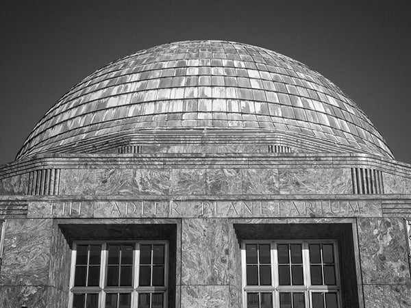 Black and white exterior photograph of Adler Planetarium in Chicago.