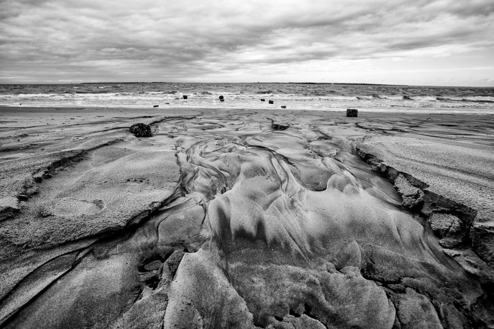 Black and white landscape photograph of a Charleston beach in winter.