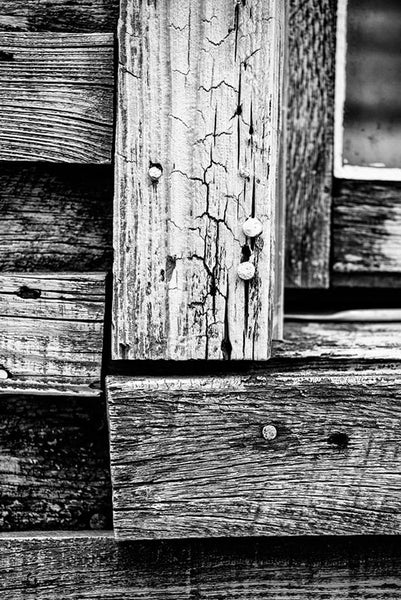 Black and white photograph of weathered boards on the exterior of the home of late blues musician Sleepy John Estes in Brownsville, Tennessee.