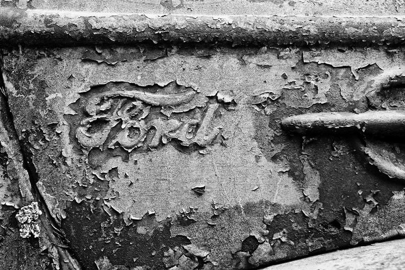 Black and white fine art photograph of an old Ford truck with peeling paint.