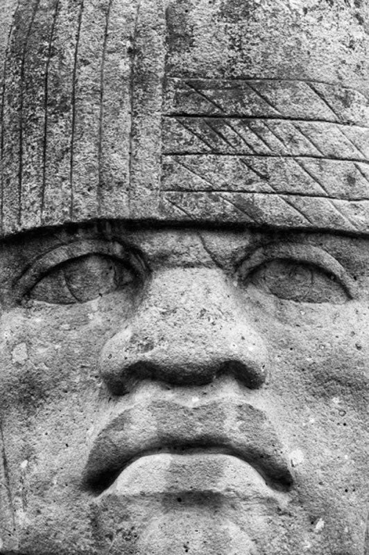 Black and white photograph of the Colossal Head, an Olmec head on display outside the National Museum of Natural History in Washington, D.C.