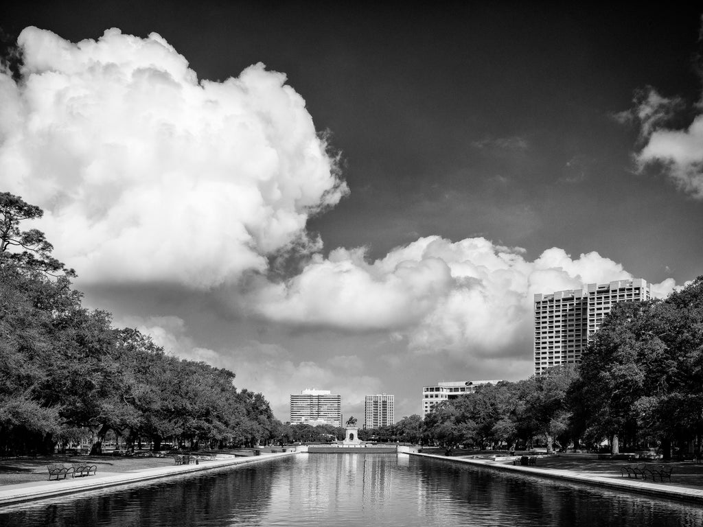 Black and white photograph looking down the long reflecting pool to the Sam Houston statute in Houston's beautiful Hermann Park.