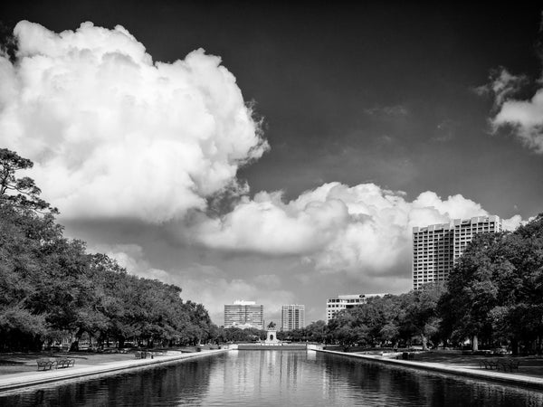 Black and white photograph looking down the long reflecting pool to the Sam Houston statute in Houston's beautiful Hermann Park.
