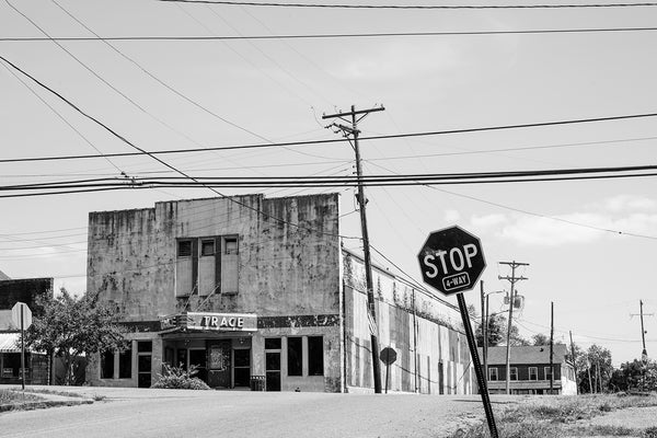 Black and white photograph of the old Trace Theater in Port Gibson, Mississippi. Built in 1870, the theater was remodeled in 1940 and was burned in a catastrophic fire that left only a hollow shell in 2020.