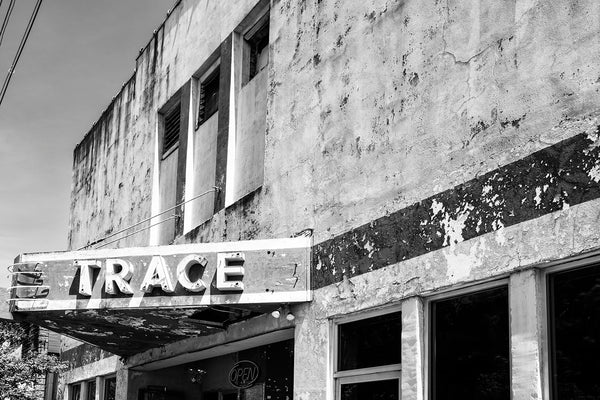 Black and white photograph of the marquee of the old Trace Theater in Port Gibson, Mississippi. Built in 1870, the theater was remodeled in 1940 and burned in a 2020 fire. It was named after the nearby Natchez Trace, which ran from Nashville to Natchez.