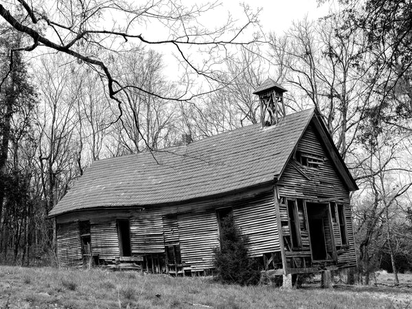 Black and white photograph of an abandoned historic one-room schoolhouse photographed in medium format along a backroad in Tennessee.