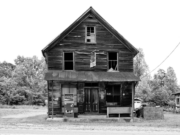 Black and white photograph of an abandoned wooden general store located in the crossroads ghost town of Auraria, Georgia.