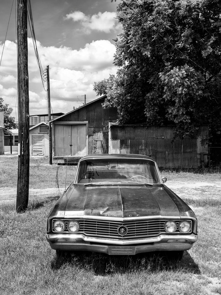 Black and white photograph of a 1960s Buick Electra automobile in the small southern town of Leslie, Georgia