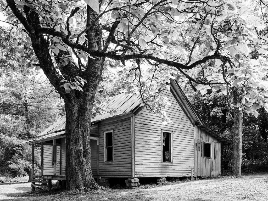 Black and white photograph of an abandoned historic house that was once inhabited by the family of a zinc miner in the now abandoned mining ghost town at Rush, Arkansas.