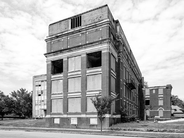 Black and white photograph of the abandoned ruins of the old Freeman Hospital building, built in 1922 and ceasing operations in 1975.