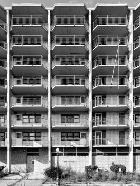 Black and white photograph of the abandoned ruins of the old Connell F. Smith Sr. Building, a public housing tower built  in 1968 along the Ohio River in Cairo, Illinois, and demolished shortly after this photograph in 2024.
