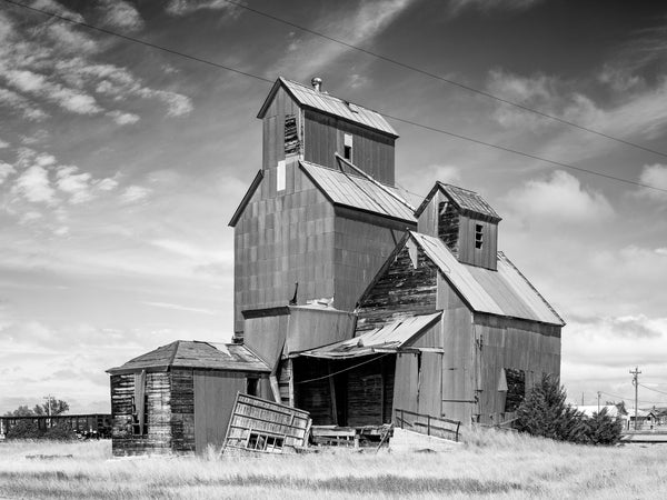 Black and white photograph of a grain elevator in a small town on the high plains of South Dakota.