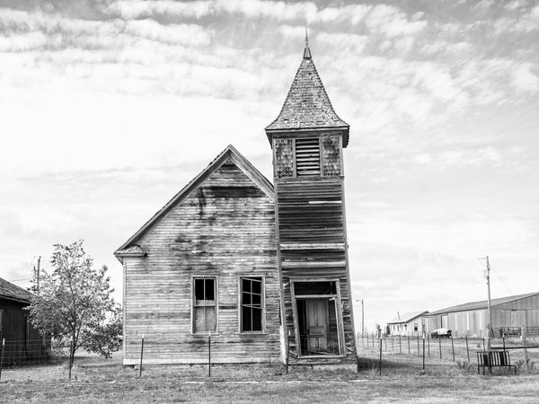 Black and white photograph of the ruins of an abandoned church in the isolated prairie ghost town at Cottonwood, South Dakota.