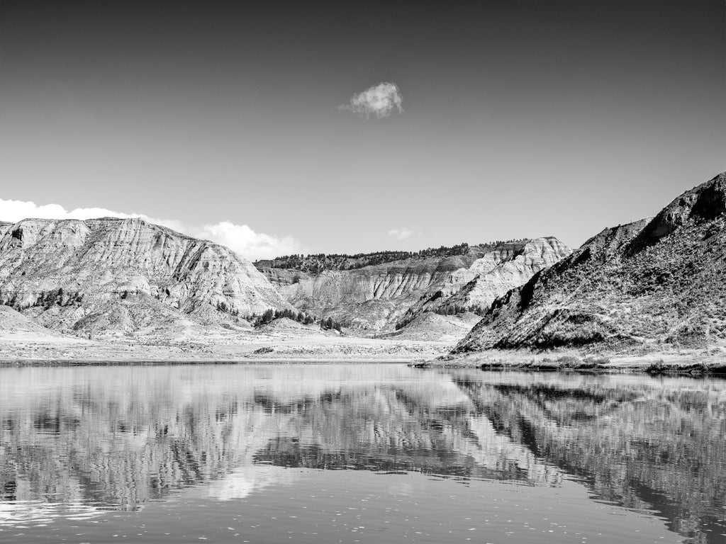 Black and white landscape photograph of a reflection in the Missouri River at the isolated Missouri Breaks region of Montana, named by the Lewis and Clark Expedition in 1806