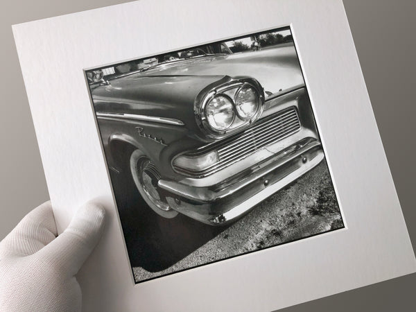 This photograph portrays the lines and curves of a classic American car. This is an original handmade black and white photograph printed by Keith Dotson in his darkroom on Ilford Classic Glossy gelatin silver fiber-based paper. This print is mounted on 4-ply acid-free white mounting board and sealed in a plastic sleeve for protection. Image size is approximately 7 x 7 inches. The mat size is 11 x 11 inches and it's ready to frame.  Signed by the artist in pencil on the back of the mounting board.