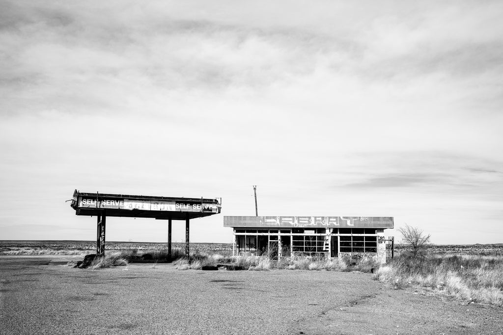 Black and white photograph of an abandoned service station on the wide open landscape of the Texas Panhandle.