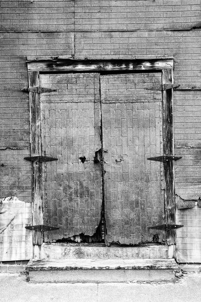 Black and white photograph of the rusty old doors of a former cotton warehouse in the small community of Newbern, Alabama. This building was previously photographed by the legendary photographer William Christenberry.