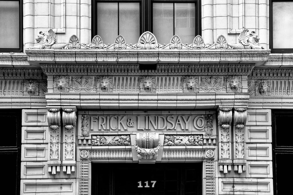 Black and white photograph of the historic and highly decorative Frick and Lindsay Company building in Pittsburgh which now serves as home to the Warhol Museum. Built in 1911, the ornate facade of the building may be surprising since Frick and Lindsay operated a plumbing supply warehouse on the premises.