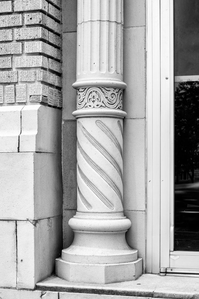 Black and white photograph of a carved stone column from the historic Temple Theatre in downtown Meridian, Mississippi.