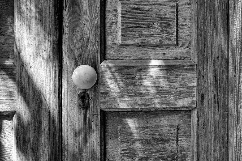 Black and white detail photograph of an old wooden door at the Union Level ghost town in Virginia.