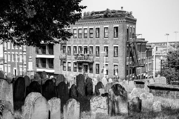 Black and white photograph of weathered headstones in the historic Copp's Hill Burying Ground established 1659 in Boston.