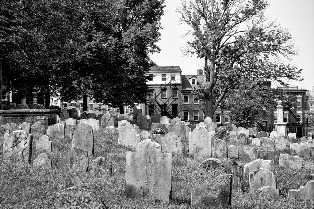 Black and white photograph of very old tombstones in the historic Copp's Hill Burying Ground established in 1659 on a hilltop in Boston.