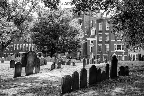 Black and white photograph of the historic 1659 Copp's Hill Burying Ground nestled into a quaint North End Boston neighborhood.