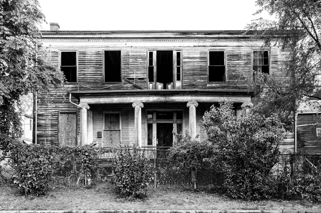 Black and white photograph of the front of the historic and abandoned Judge Mark Bird House, built circa 1840 in Woodstock, Virginia. The house also once served as home for the Woodstock Female Seminary.