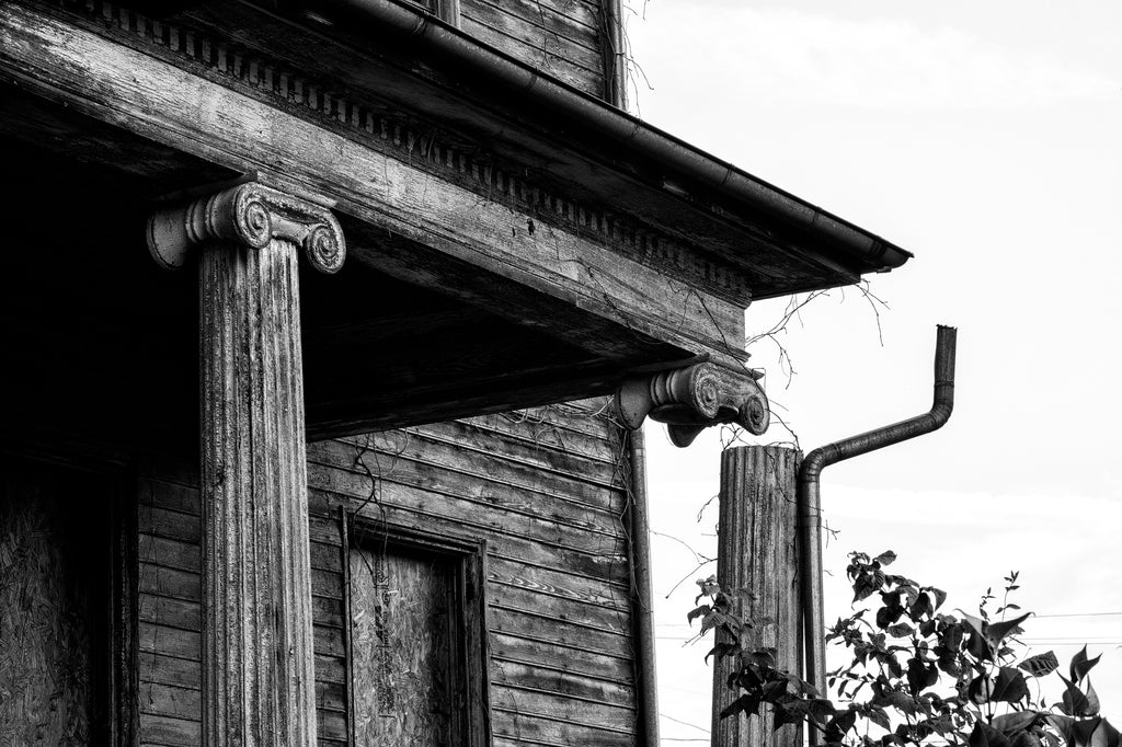 Black and white photograph of a broken column on the front of the historic and abandoned Judge Mark Bird House, built circa 1840 in Woodstock, Virginia. The house also once served as home for the Woodstock Female Seminary.