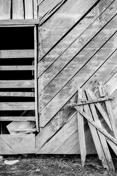 Black and white photograph of the weathered wooden exterior of the abandoned 1890s Jimmy Davis Homestead at Dog Cove, Tennessee.