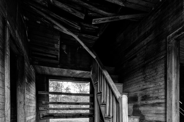 Black and white photograph of the inside of the abandoned 1890s farmhouse on the Jimmy Davis Homestead in Dog Cove, Tennessee.