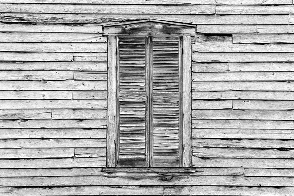 Black and white photograph of weathered window shutters and clapboards outside the historic Hamilton-Lay General Store, built by Alexander Lafayette "Fate" Hamilton near Washburn, Tennessee.