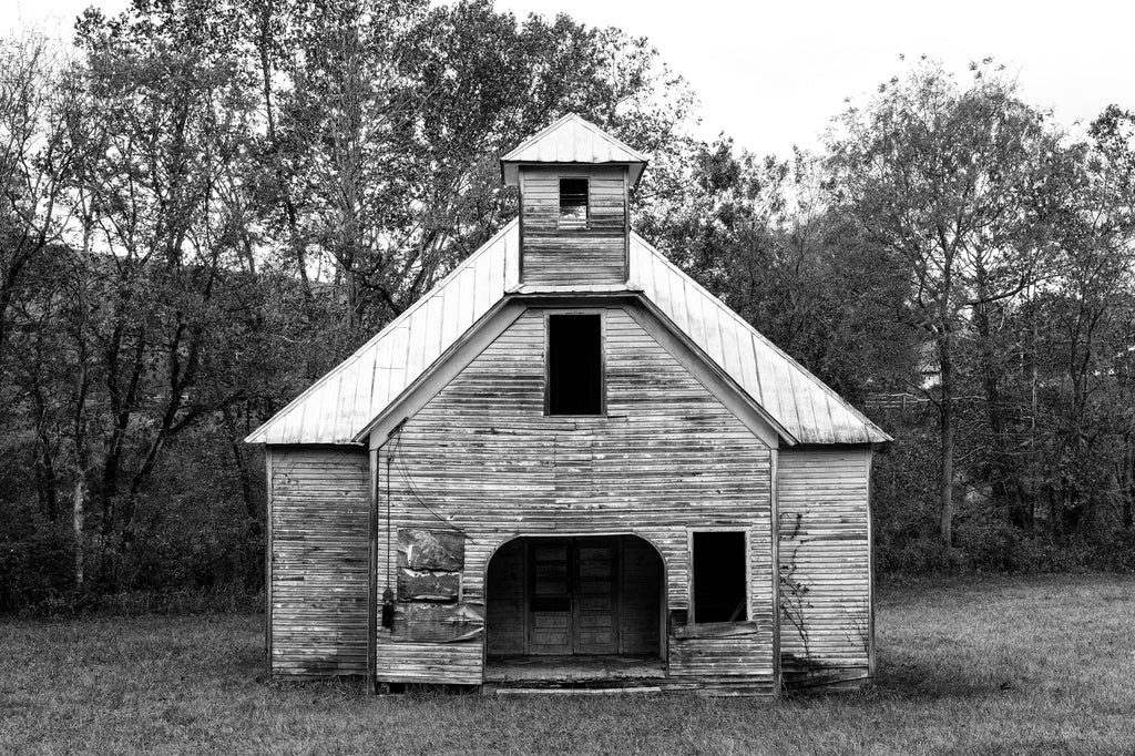 Black and white photograph of the long-abandoned Lays Gap Schoolhouse found along a backroad in East Tennessee.