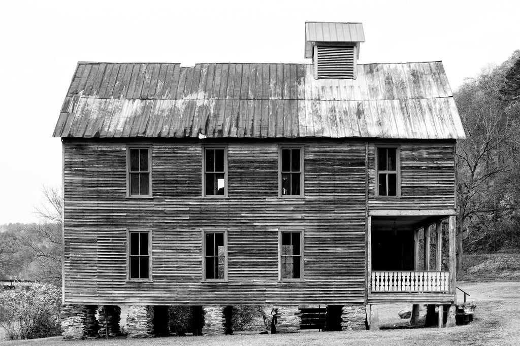 Black and white side view photograph of the Hiwassee Meeting Hall, built in 1899 by a partnership of the local Hiwassee Union Church and the Masons. The church met on the first floor and the Masons met on the second floor. During the week, the first floor served as a school.