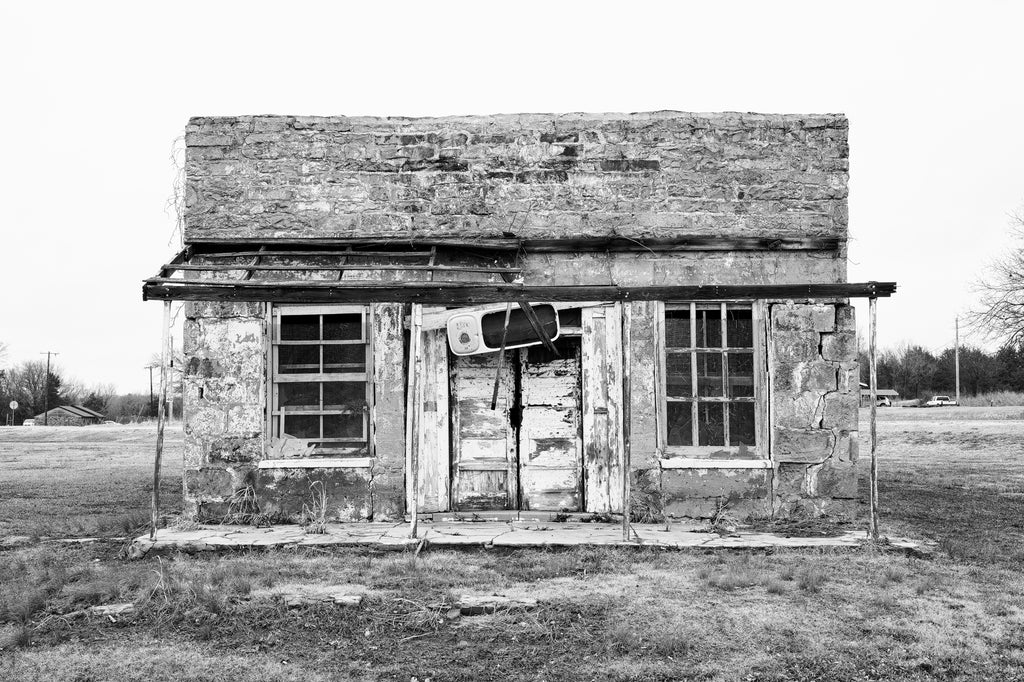 Black and white photograph of the historic abandoned Abe Lincoln Trading Company, built 1903 in Clearview, Oklahoma. It's often called the Last Chance Bar or the Juke Joint, which occupied the building in later years. The building was added to the National Register of Historic Places in December, 2023.