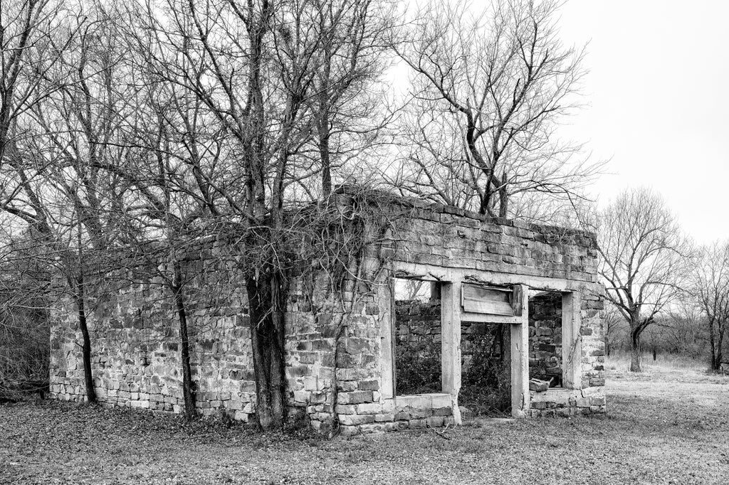 Black and white photograph of the ruins of a historic stone block storefront in Clearview, Oklahoma.
