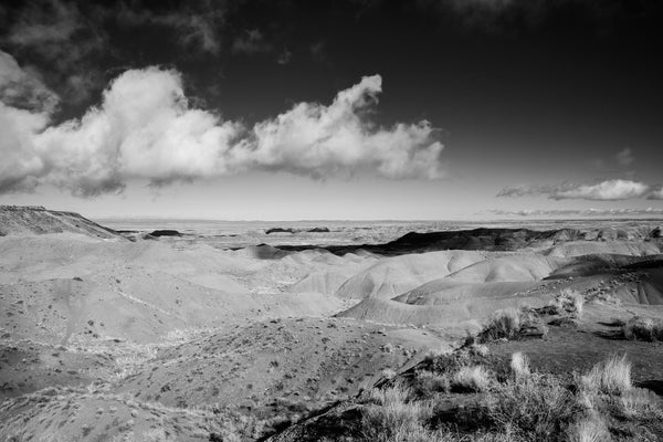 Black and white photograph of clouds drifting low over the beautiful painted desert landscape of Arizona.