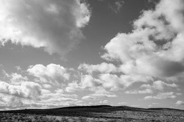 Black and white photograph clouds over the Arizona landscape.
