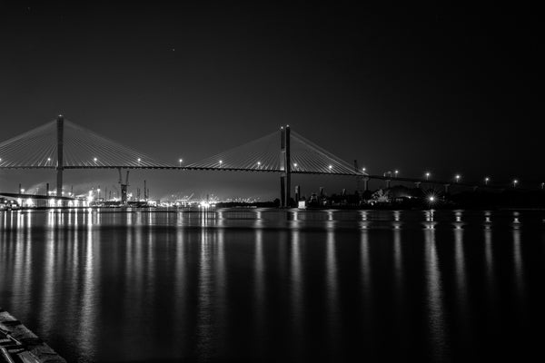 Black and white photograph the Savannah River at night as seen from the city's iconic River Street.