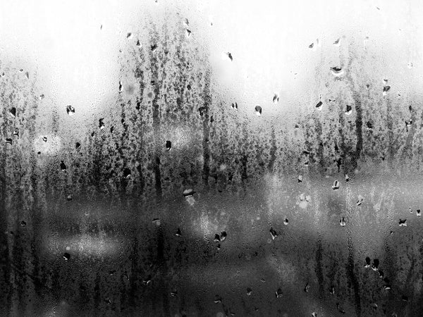 Black and white photograph of window condensation droplets on a car window resulting from the notoriously hot and humid atmosphere of the Mississippi Delta region.