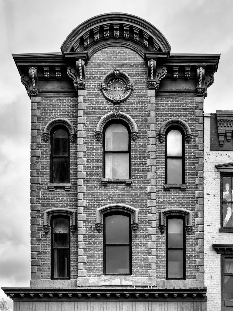 Black and white photograph of the historic First National Bank building dated 1867 in downtown Amsterdam, New York.