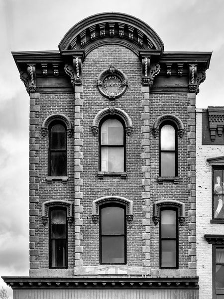Black and white photograph of the historic First National Bank building dated 1867 in downtown Amsterdam, New York.